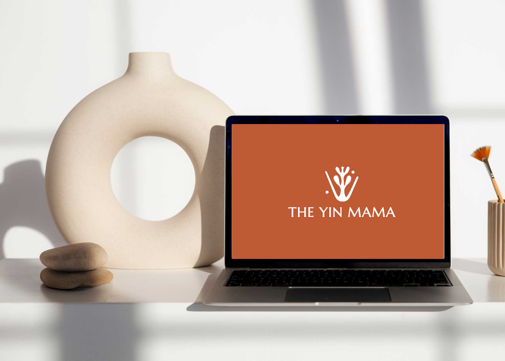 The Yin Mama site shown on a laptop mockup